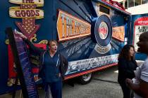 An office worker plays a carnival game for a free sample at an Amazon Treasure Truck at The Par ...