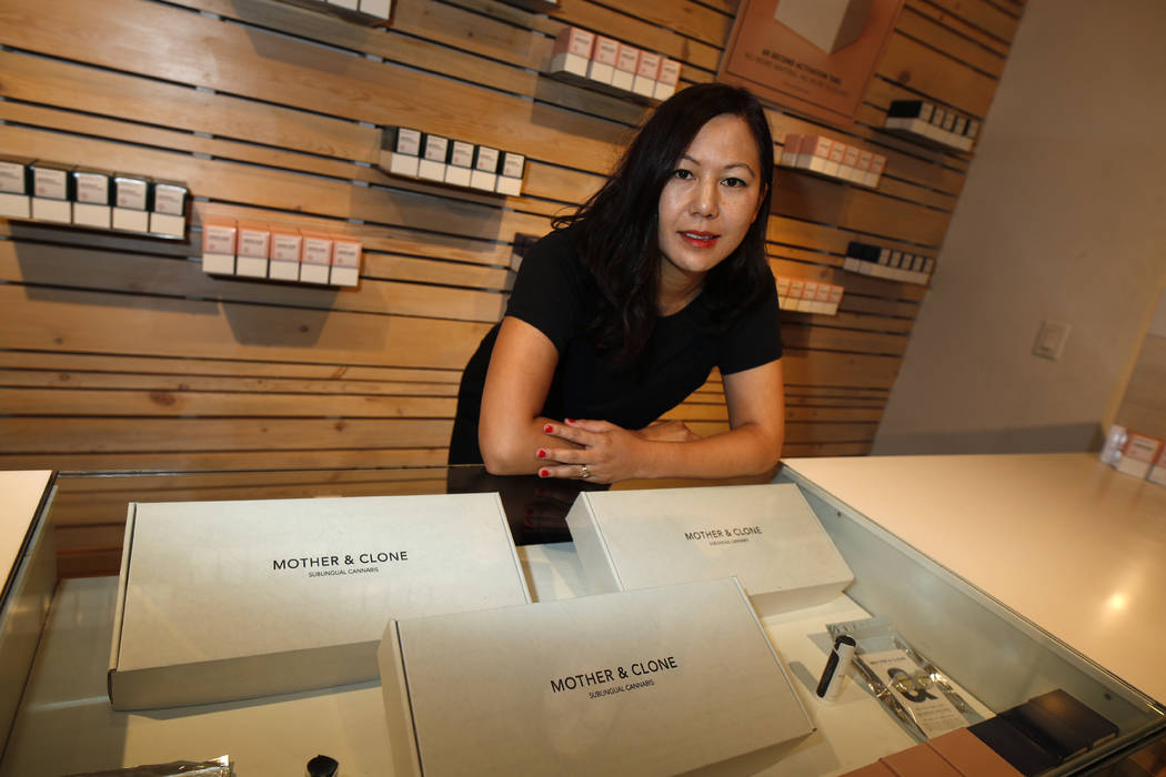 In this Friday, July 26, 2019 photo, Leslie Siu poses for a portrait next to her cannabis spray ...