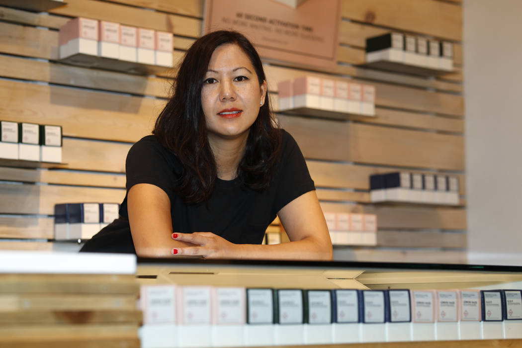 In this Friday, July 26, 2019 photo, Leslie Siu poses for a portrait next to her cannabis produ ...