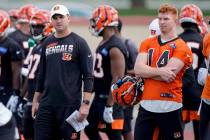 Cincinnati Bengals head coach Zac Taylor and quarterback Andy Dalton (14) watch practice during ...