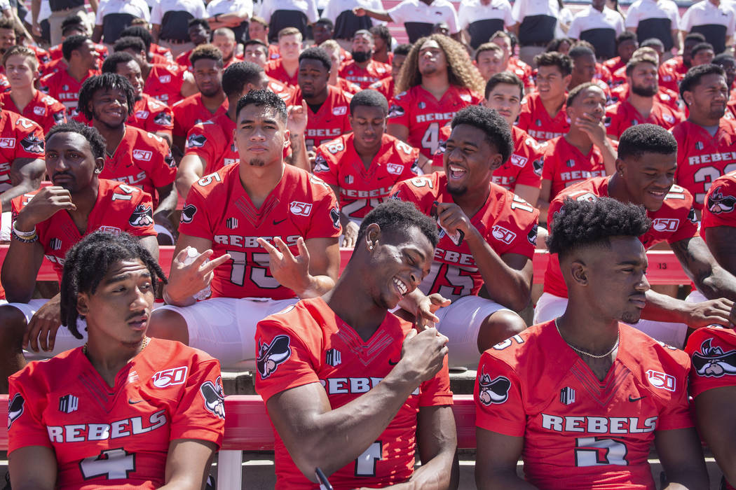 UNLV football players get into place during the team's photo day at Sam Boyd Stadium in Las Veg ...