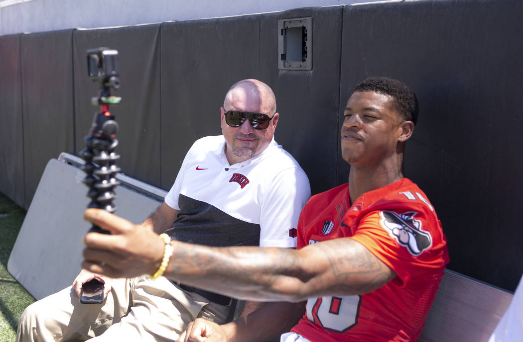 UNLV Rebels head coach Tony Sanchez, left, and linebacker Javin White (16), shoot a selfie vide ...