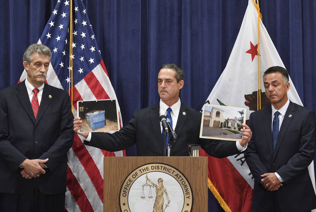 Orange County District Attorney Todd Spitzer holds up pictures of the home of Peter Chadwick an ...