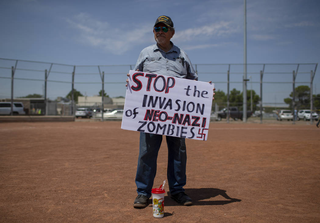 Gilberto Zuniga holds a sign to protest the visit of President Donald Trump to the border city ...