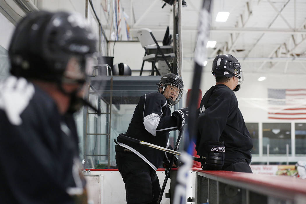 Player Arthur Wong, centers gets onto the ice during Ronnie's Hockey Club, a pickup ice hockey ...