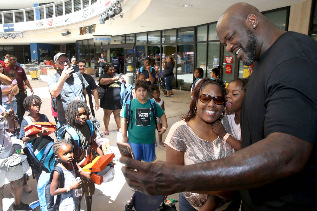 Terri Ware and her daughter Micah Ware Broady, 9, of Las Vegas pose with former NBA star Shaqui ...