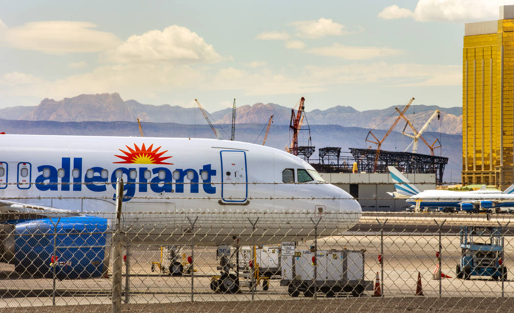 An Allegiant Air plane sits on the tarmac at McCarran International Airport in Las Vegas with t ...