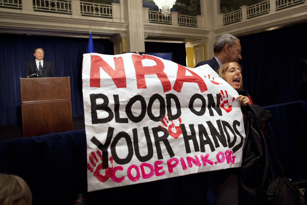 FILE - In this Dec. 21, 2012, file photo, activist Medea Benjamin, of Code Pink, is led away by ...