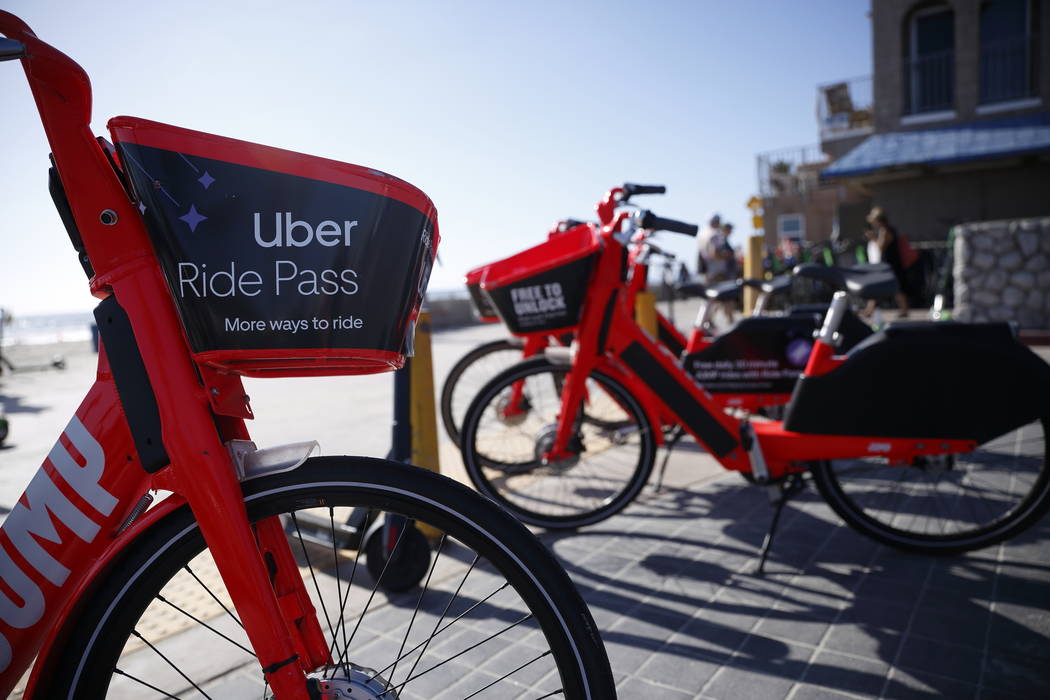 FILE - In this May 28, 2019, file photo Jump electric bike share bicycles by Uber are seen alon ...