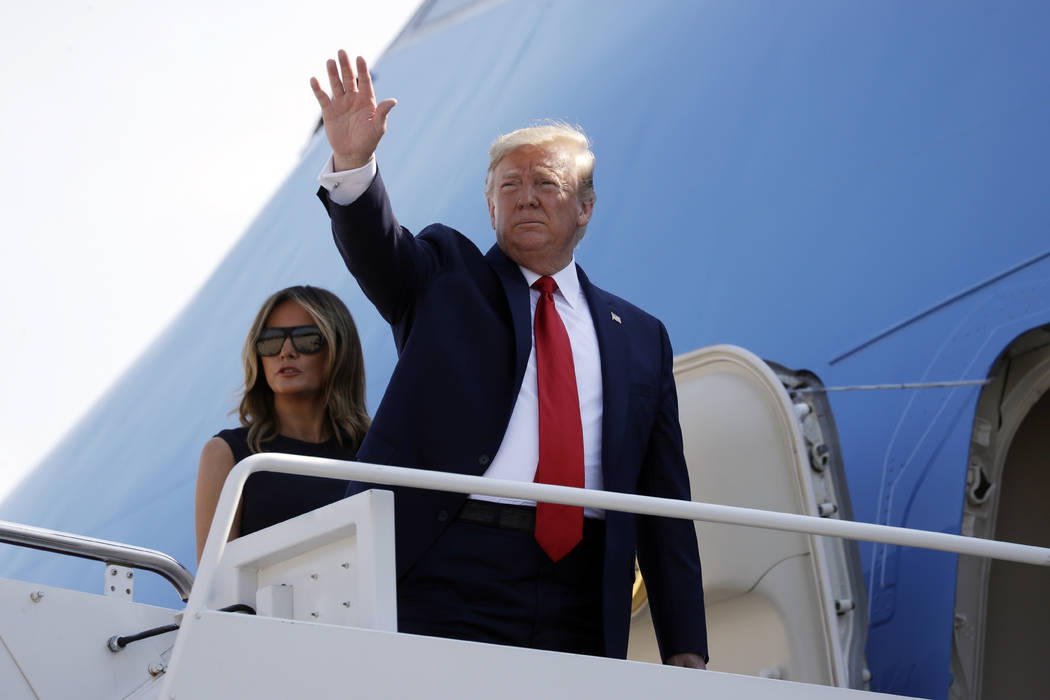 In this Aug. 7, 2019, photo, President Donald Trump and first lady Melania Trump board Air Forc ...