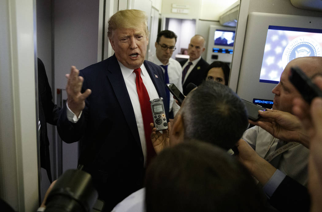 President Donald Trump talks to reporters aboard Air Force One after visiting Dayton, Ohio and ...