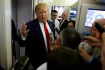 President Donald Trump talks to reporters aboard Air Force One after visiting Dayton, Ohio and ...