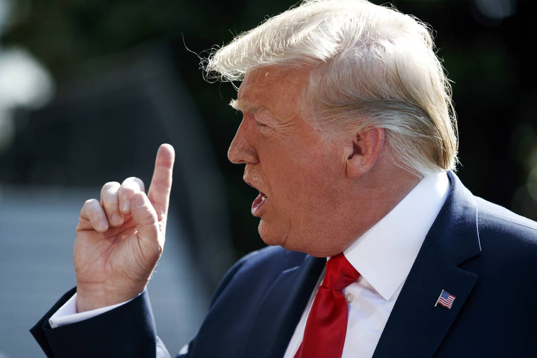 President Donald Trump talks to reporters on the South Lawn of the White House, Friday, Aug. 9, ...