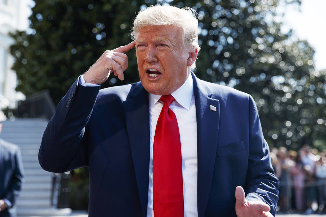 President Donald Trump talks to reporters on the South Lawn of the White House, Friday, Aug. 9, ...