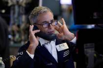 Specialist Anthony Rinaldi works on the floor of the New York Stock Exchange, Friday, Aug. 9, 2 ...