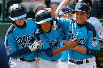 Las Vegas' Dominic Clayton, center, celebrates with teammates Josh Zuehlsdorff, left, and Dillo ...