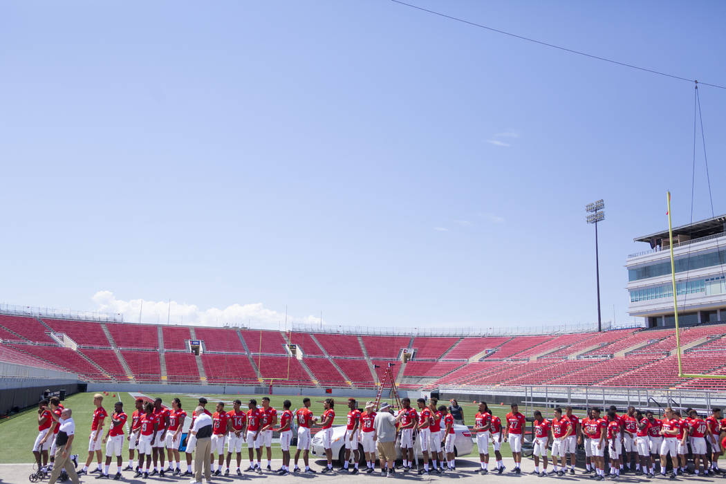 UNLV football players get into place during the team's photo day at Sam Boyd Stadium in Las Veg ...