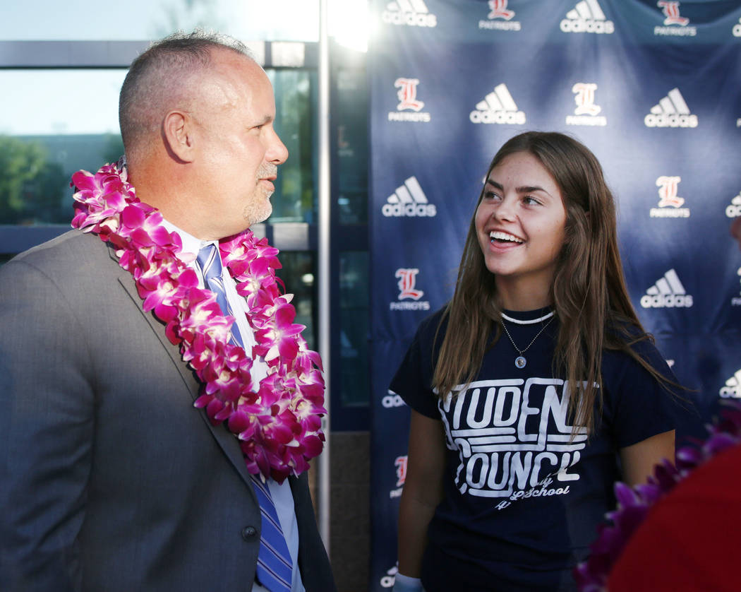 Liberty High School principal Derek Bellow, left, and student body president Sydney James great ...