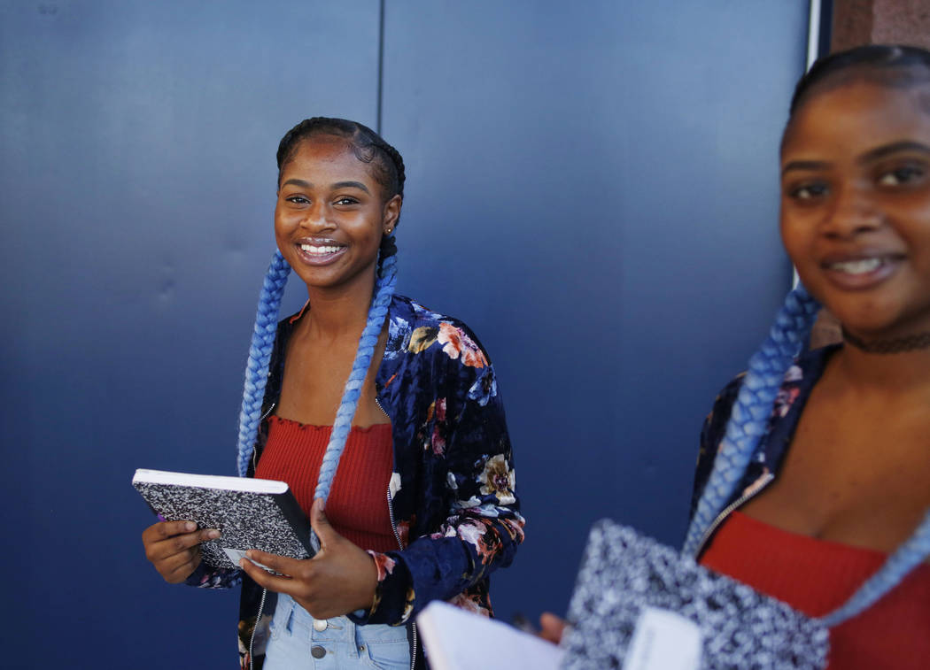 Sophomores Tashira, left, and Dashira McKay, 15, arrive on the first day of school at Liberty H ...