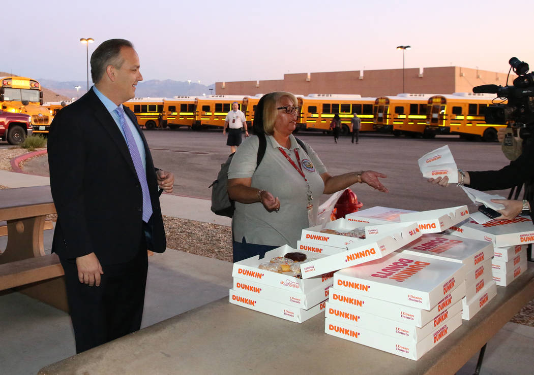 Clark County School District Superintendent Dr. Jesus F. Jara, left, offers donuts to CCSD bus ...
