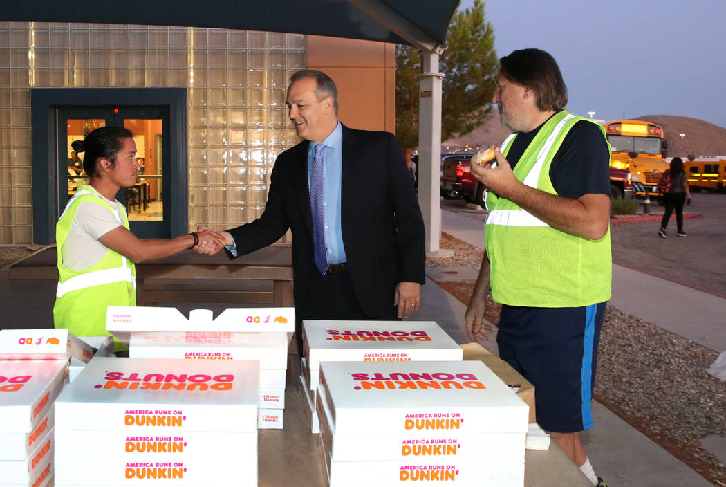 Clark County School District Superintendent Dr. Jesus F. Jara, center, shakes hands with Karl V ...