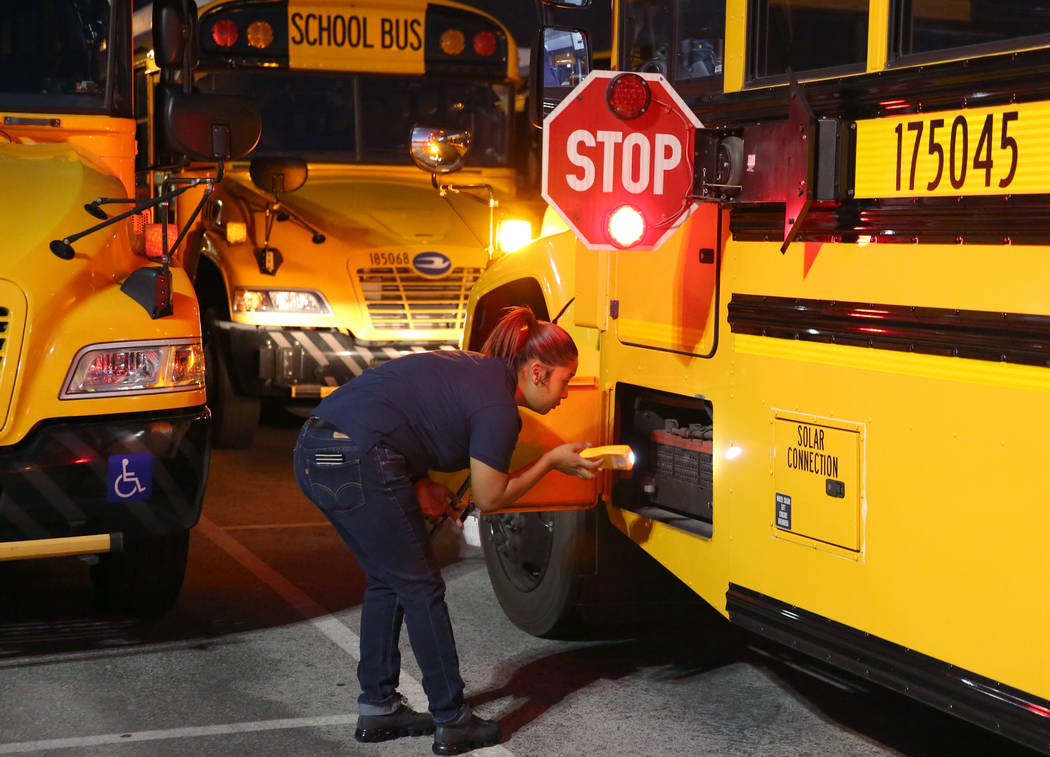 Clark County School District bus driver Alexis Quon inspects her bus at the Wallace Transportat ...