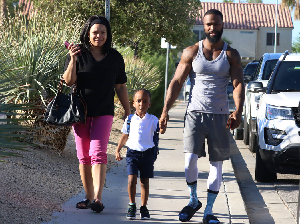 Khylan Bush, 4, accompanied by his mother Belle, left, and his father Warren arrives at Roger G ...