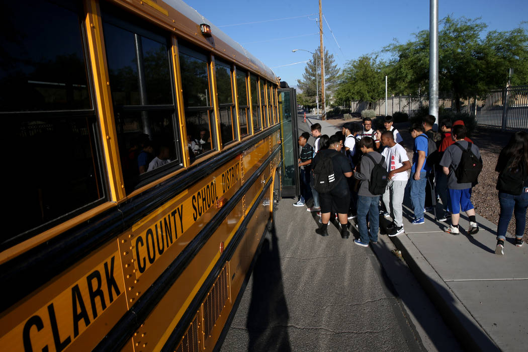 Sunrise Mountain High School students board the school bus at East Owens Avenue and North Beesl ...