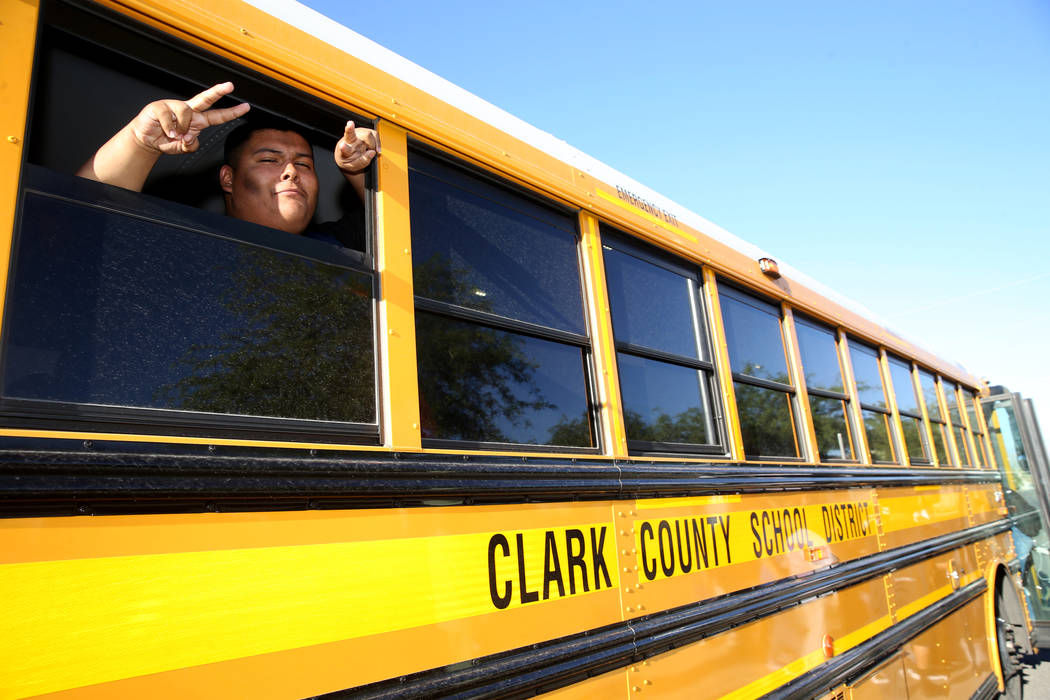 A Sunrise Mountain High School student poses on the school bus at East Owens Avenue and North B ...