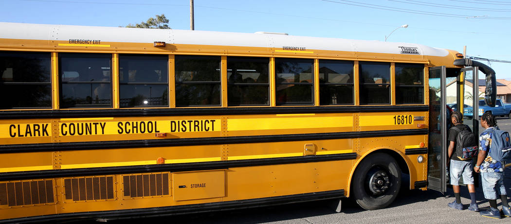 Sunrise Mountain High School students board the school bus at East Owens Avenue and North Beesl ...