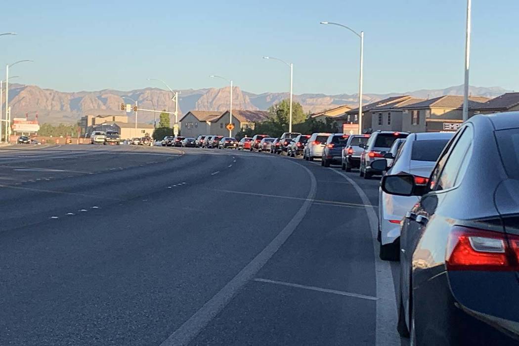 Cars are lined up at Liberty High School for the first day of the 2019-20 school year, Monday, ...