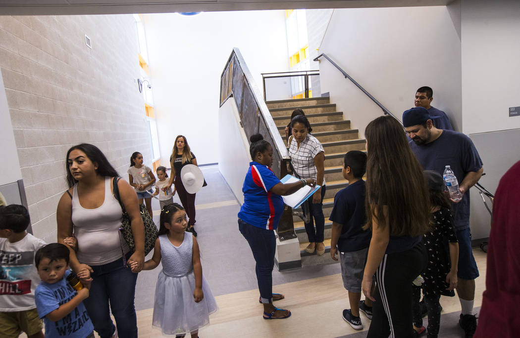 Literary specialist Paige Washington, center, assists students and parents in finding their cla ...