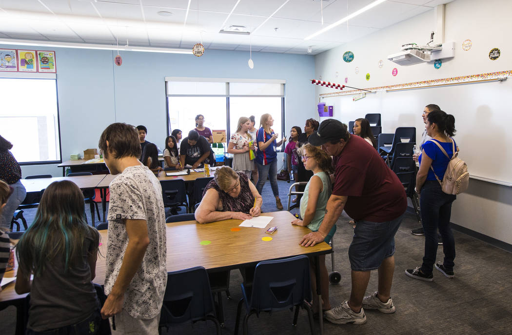 Students and parents explore classrooms after a ribbon-cutting ceremony for Earl Jenkins Elemen ...