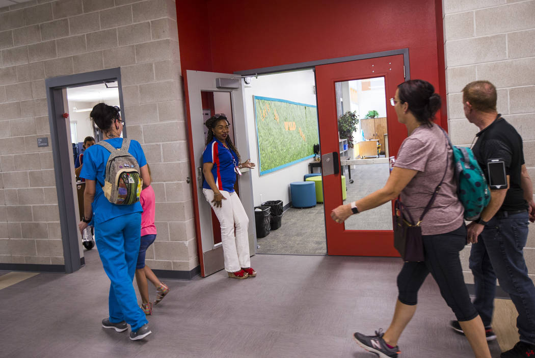 Librarian Kimberly Murray welcomes visitors after a ribbon-cutting ceremony for Earl Jenkins El ...