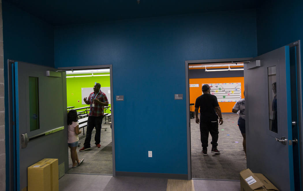 Physical education teacher Parnell Graham, left, talks with students after a ribbon-cutting cer ...