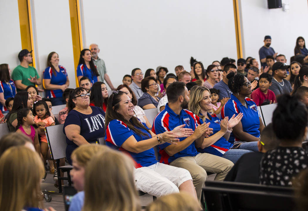 Teachers, center, are cheered on during a ribbon-cutting ceremony for Earl Jenkins Elementary S ...