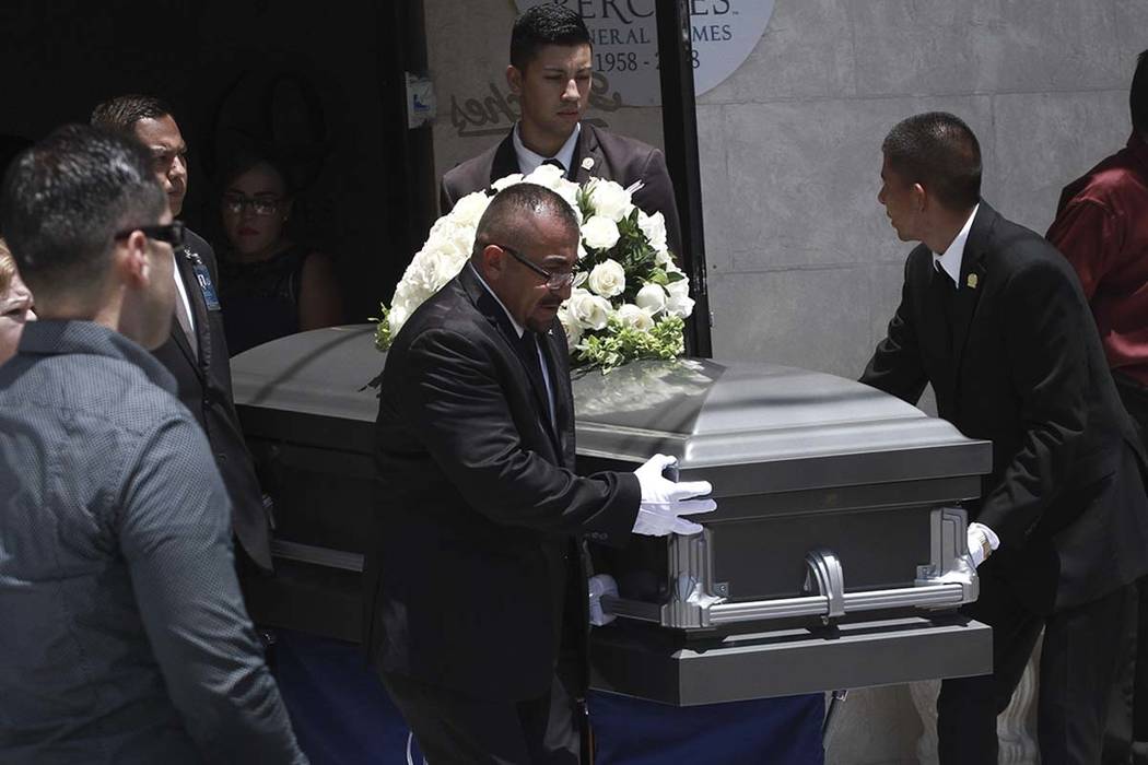 Pall bearers roll out the casket containing the remains of Ivan Manzano, who was killed in the ...