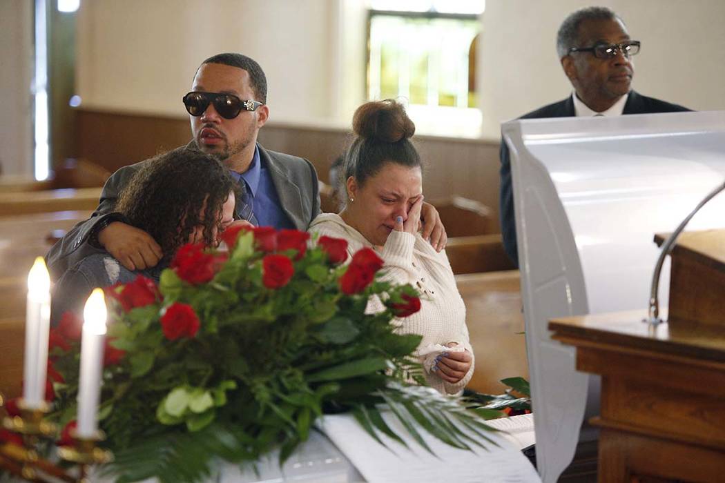 Friends and family mourn Derrick Fudge on Saturday, Aug. 10, 2019, at a church in Springfield, ...