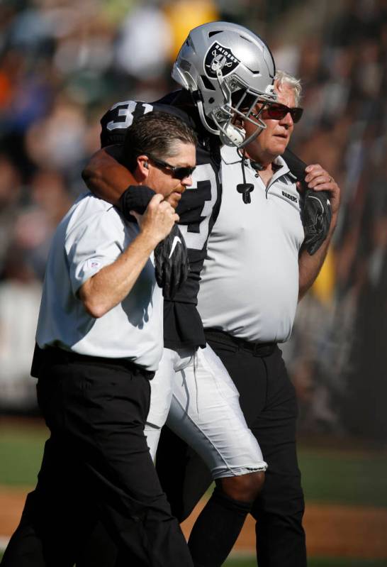 Oakland Raiders' Isaiah Johnson is assisted off the field during the first half of a preseason ...