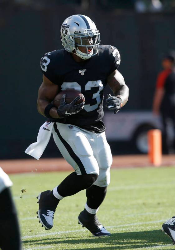 Oakland Raiders' DeAndre Washington rushes against the Los Angeles Rams during the first half o ...