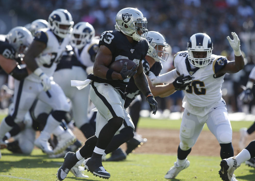 Oakland Raiders' DeAndre Washington (33) runs against the Los Angeles Rams during the first hal ...