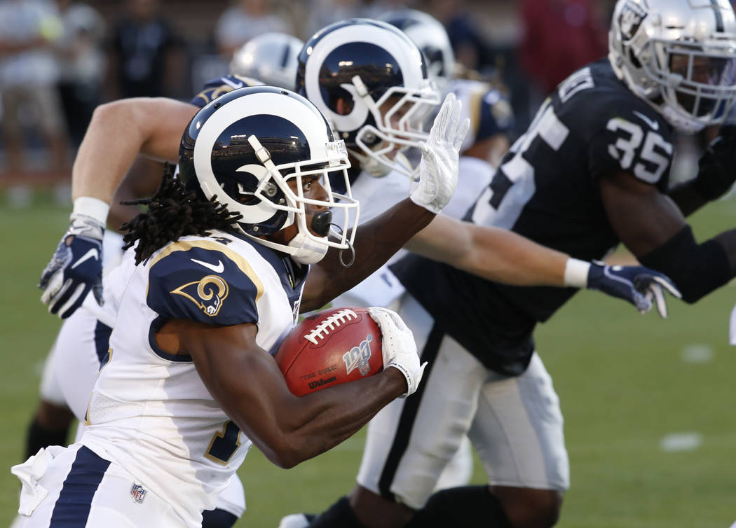 Los Angeles Rams' Nsimba Webster, left, rushes against the Oakland Raiders during the second ha ...