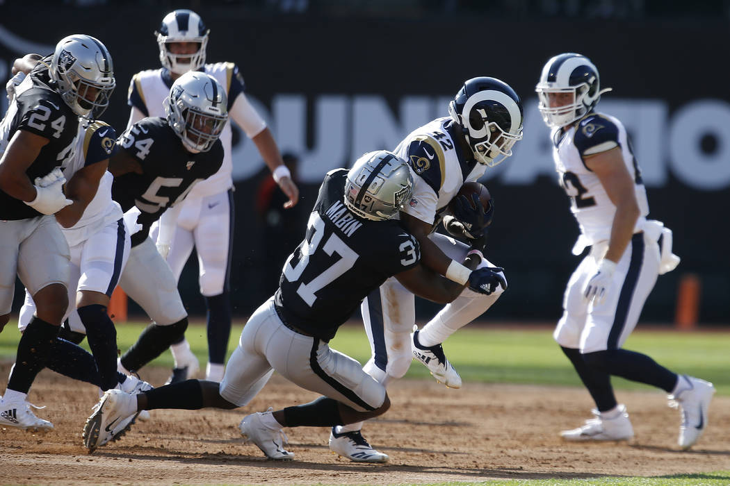 Oakland Raiders' Dylan Mabin (37) tackles Los Angeles Rams' John Kelly (42) during the first ha ...