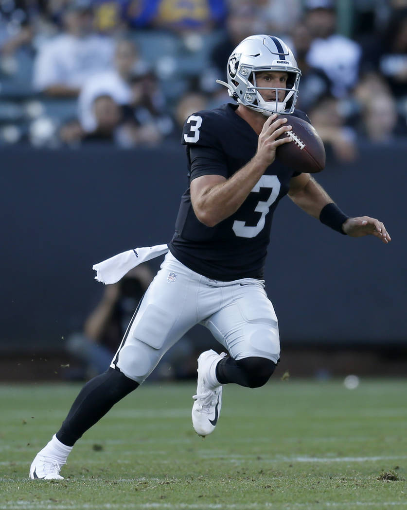 Oakland Raiders quarterback Nathan Peterman scrambles during the second half of a preseason NFL ...