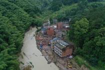 Rescuers search for victims of a landslide triggered by Typhoon Lekima in Yongjia county in eas ...