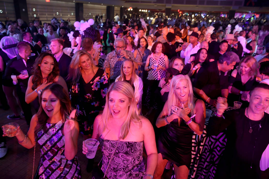 Guests take in the entertainment during the Aid for AIDS of Nevada 33rd Annual Black & Whit ...