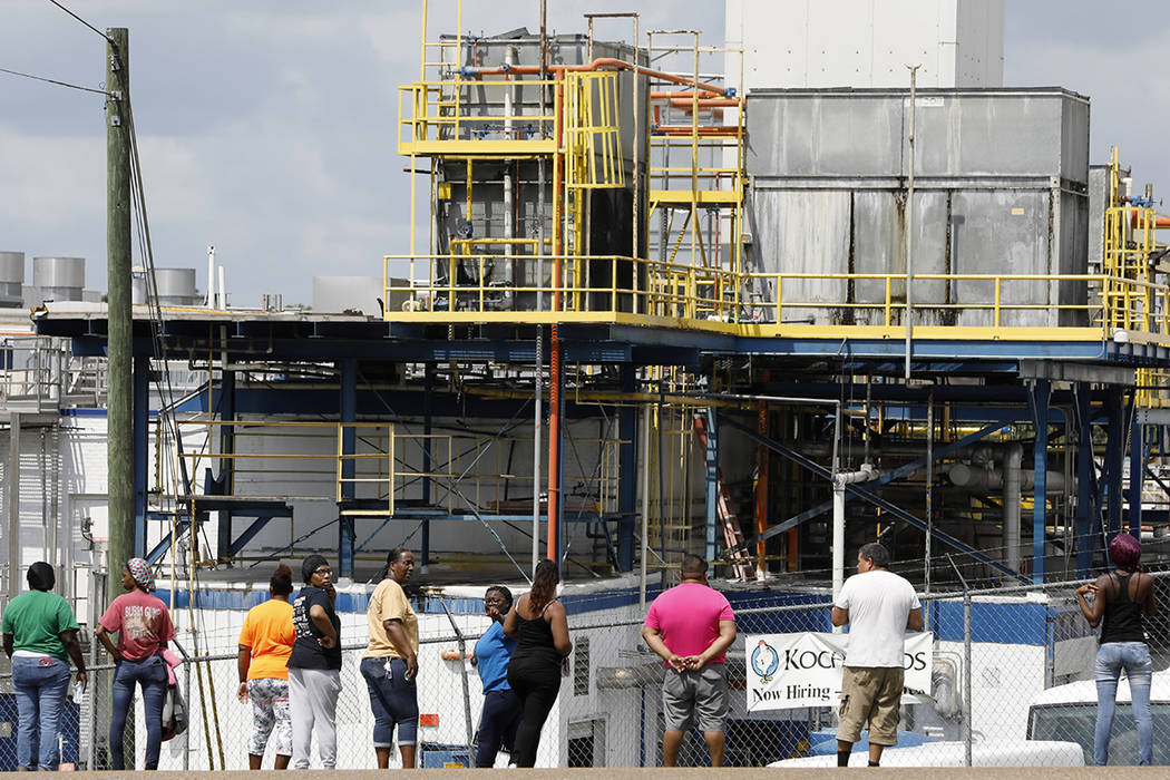 Friends, coworkers and family watch as U.S. immigration officials raid several Mississippi food ...