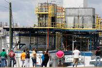 Friends, coworkers and family watch as U.S. immigration officials raid several Mississippi food ...