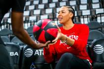 Las Vegas Aces' Liz Cambage hands a signed ball over ahead of the WNBA All-Star Game and skills ...