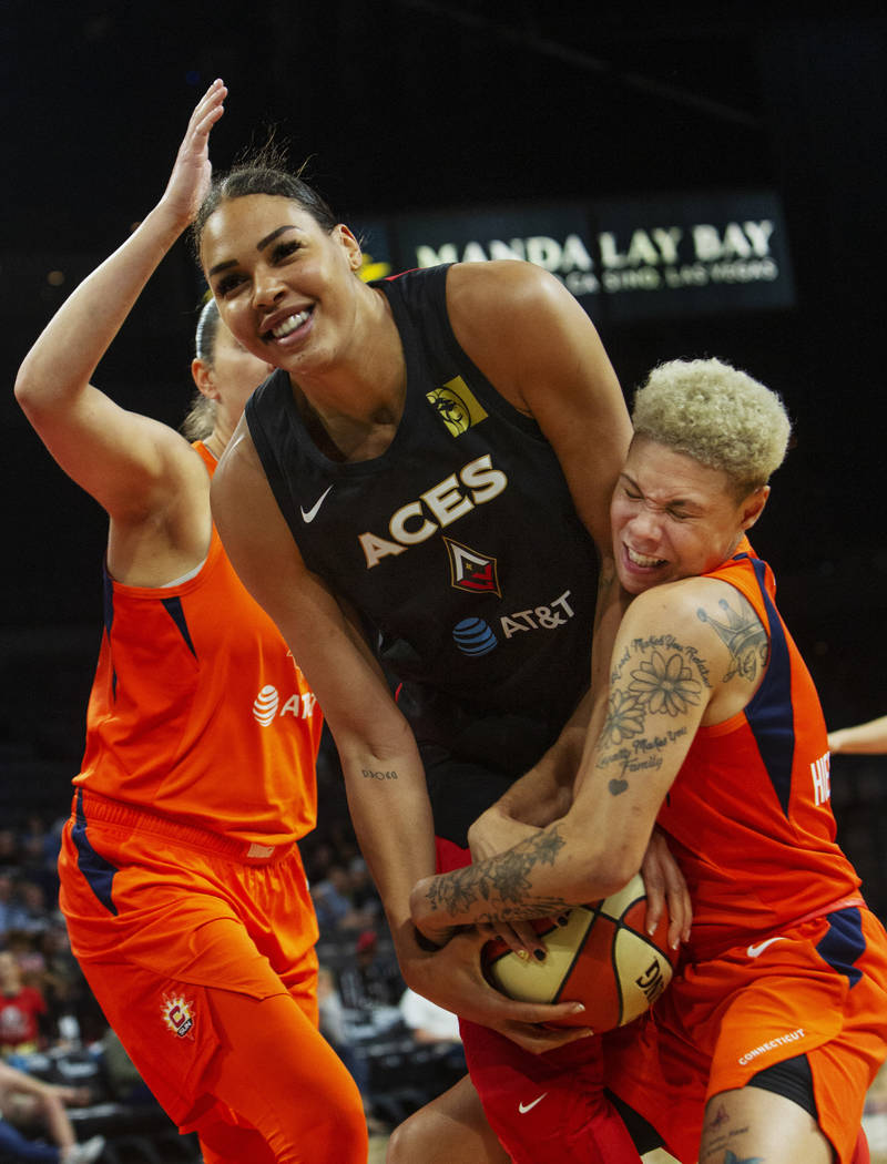 Las Vegas Aces center Liz Cambage (8) laughs as Connecticut Sun guard Natisha Hiedeman (2) trie ...